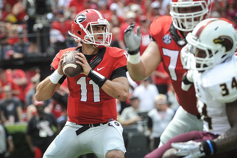 Georgia quarterback Greyson Lambert drops back to pass against Louisiana Monroe linebacker Michael Johnson (34) during the first half of an NCAA college football game, Saturday, Sept., 5, 2015, in Athens, Ga.