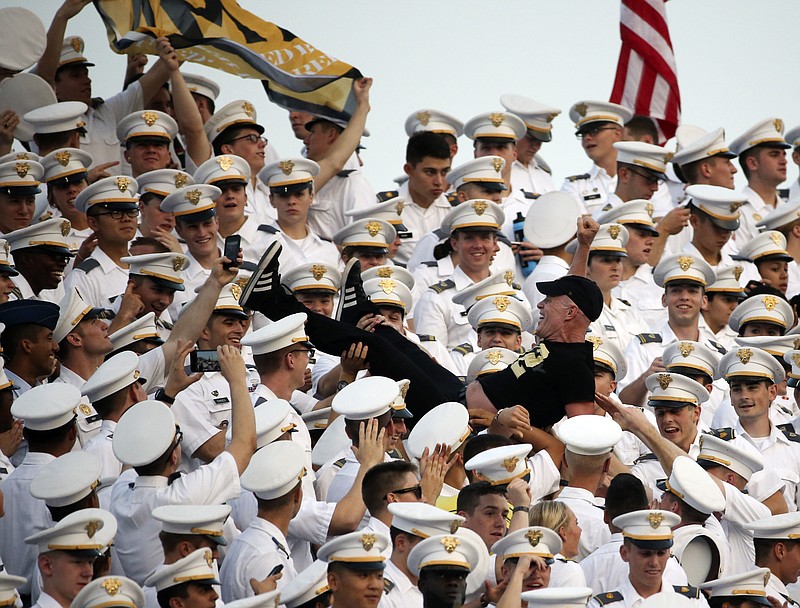 In this Friday, Sept. 4, 2015 photo, a man is passed through the cadet cheering section during the first half of an NCAA college football game between Army and Fordham in West Point, N.Y. Two dozen cadets suffered concussions on Aug. 20, 2015, during the annual pillow fight by first year students known as "plebes." Some cadets swung pillow cases filled with hard objects according to a story in the New York Times, published Saturday, Sept. 5. 