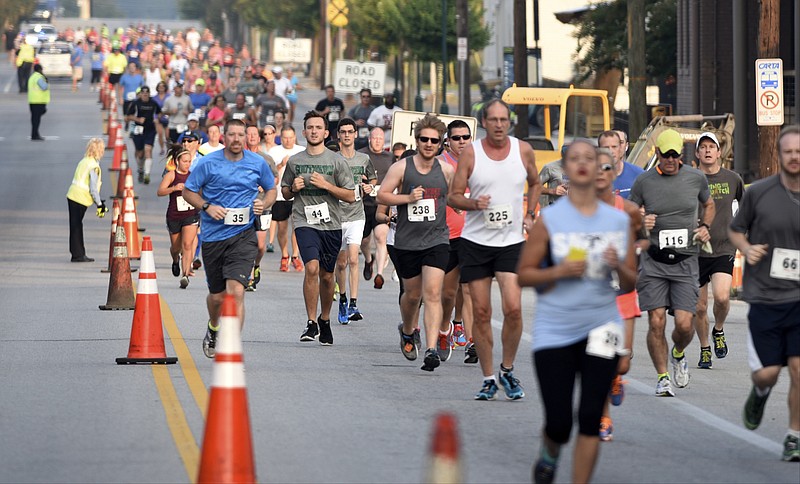 Runners head east on Main Street near the beginning of the Run of Honor on Sunday, Sept. 6, 2015, in Chattanooga, Tenn. The eight-kilometer race that began and ended at Finley Stadium raised money for the Tim Chapin Scholarship Fund and the Fort Campbell Fisher House.