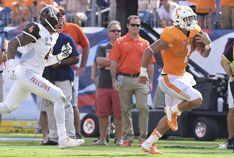 Tennessee running back Jalen Hurd picks up yardage down the sidelines while being chased by Bowling Green's Eilar Hardy during Saturday's game in Nashville. Hurd is confident in the potential for this year's Volunteers, who are among the many college football teams still filled with championship aspirations after the opening week of play.
