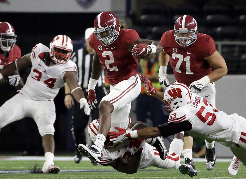 Alabama running back Derrick Henry (2) carries against Wisconsin defenders T.J. Edwards (53) and Leon Jacobs, bottom, during the first half of an NCAA college football game Saturday, Sept. 5, 2015, in Arlington, Texas. 