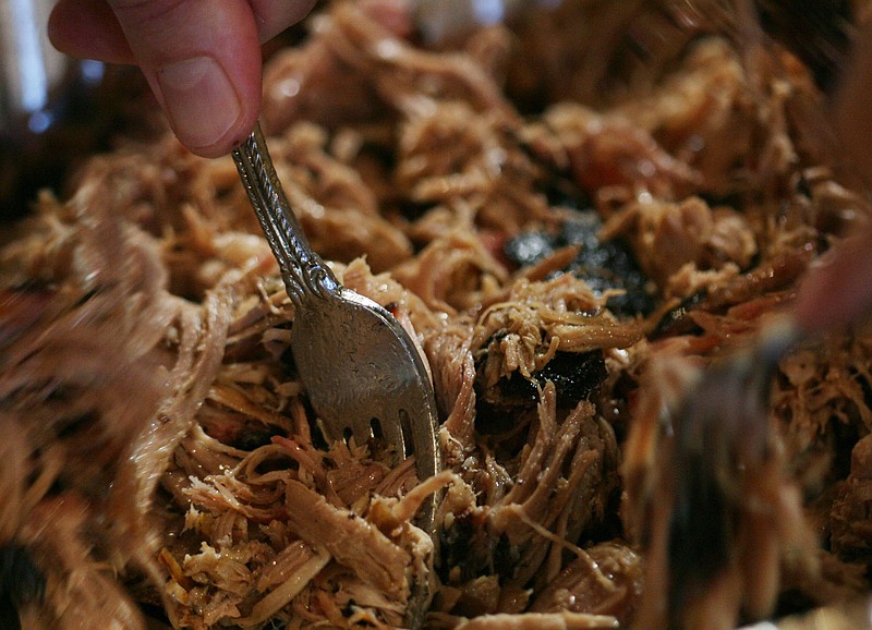 Pulled pork is shred with forks for Slow-roasted Pork Mini-sliders during a cooking class demostrating grilling recipes and tips, offered by local chef Wendy Carroll, in Fresno, California. (Eric Paul Zamora/Fresno Bee/MCT)