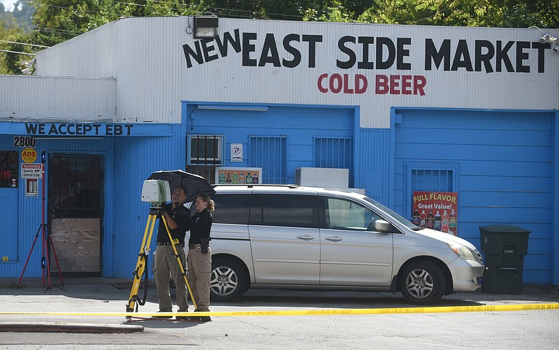 Chattanooga police officers work the scene of a homicide Monday, September 7, 2015 at the New East Side Market at the corner of 4th Avenue and 28th Street.