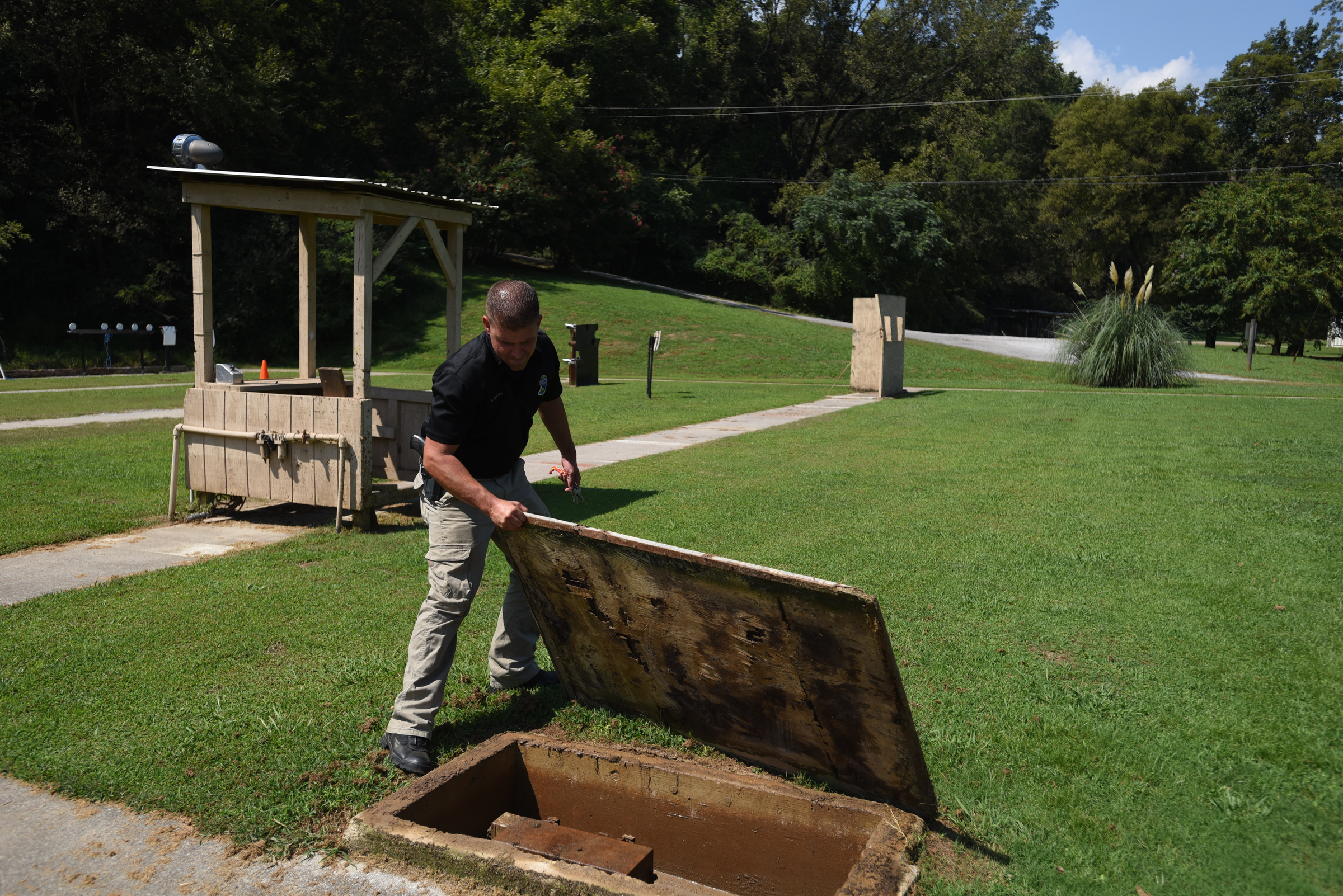 Officer Joe Sabba opens the lid to a non-functioning electric box Thursday, September 3, 2015 at the police firing range on Moccasin Bend Road.