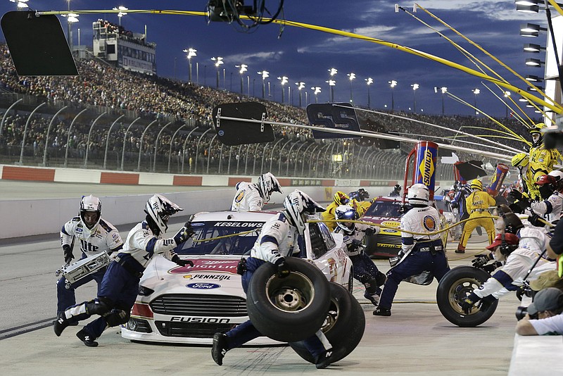 Crew members for Brad Keselowski perform a pit stop during a NASCAR Sprint Cup auto race at Darlington Raceway, Sunday, Sept. 6, 2015, in Darlington, S.C. 
