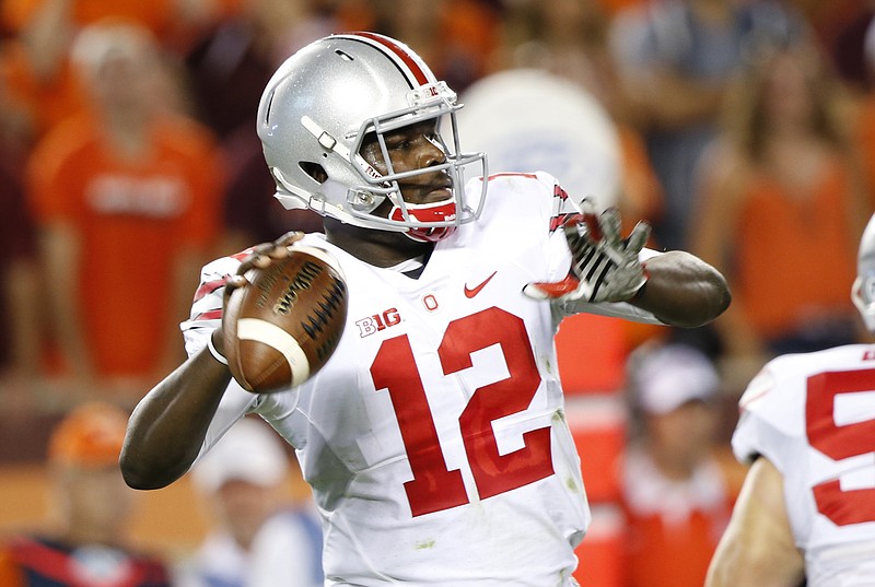 Ohio State quarterback Cardale Jones (12) looks for a receiver during the first half of an NCAA college football game against Virginia Tech in Blacksburg, Va., Monday, Sept. 7, 2015.
