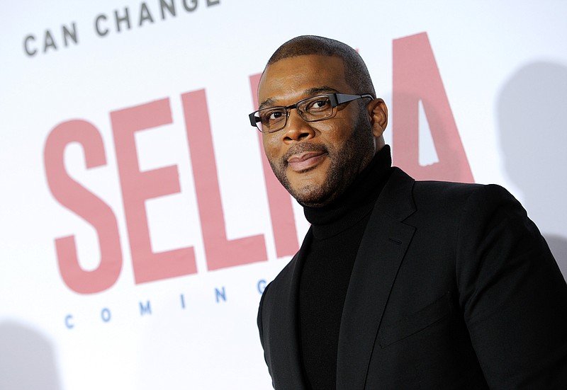 In this Sunday, Dec. 14, 2014, file photo, Tyler Perry attends the premiere of "Selma" at the Ziegfeld Theatre in New York. Perry recently met with a group of Tanzanian children with albinism who are living in a home the filmmaker helped fund.