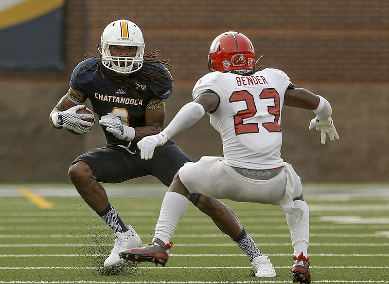 UTC wide receiver Alphonso Stewart breaks around Jacksonville State linebacker Brandon Bender during the Mocs' season-opener football game against Jacksonville State at Finley Stadium on Saturday, Sept. 5, 2015, in Chattanooga.