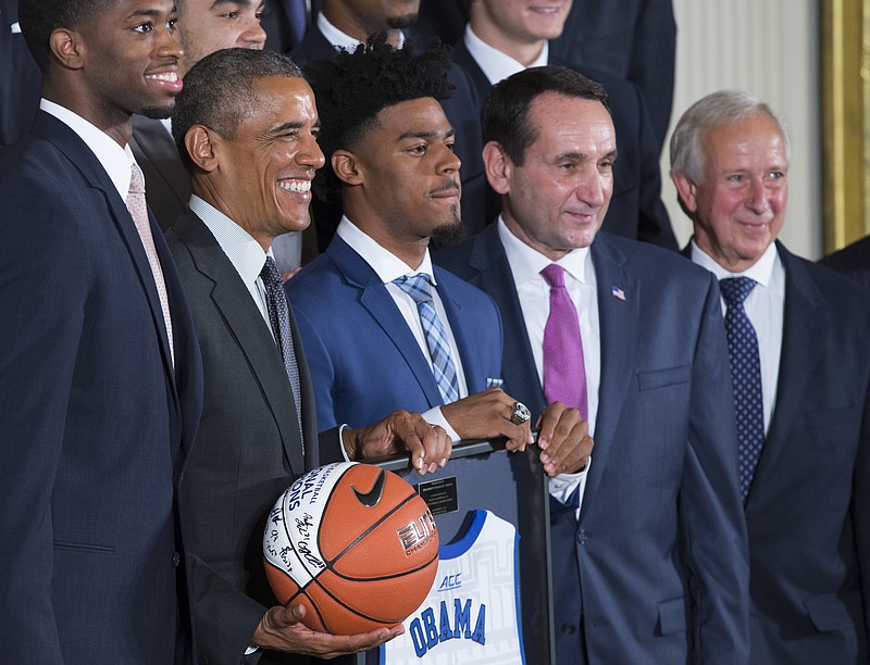 
              President Barack Obama, second from left, poses for photographs during a ceremony in the East Room of the White House honoring the NCAA Champion Duke Blue Devils men’s basketball team, on Tuesday, Sept. 8, 2015, in Washington. From left, co-captain Amile Jefferson, Obama, co-captain Quinn Cook, coach Mike Krzyzewski, and University president Richard Brodhead. (AP Photo/Evan Vucci)
            