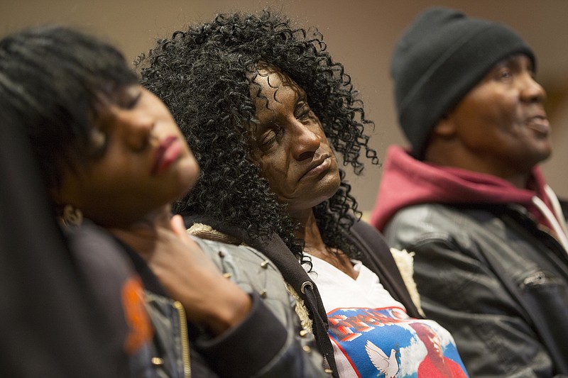 In this April 27, 2015, file photo, family members of Freddie Gray, sister Fredricka Gray, left, mother Gloria Darden, center, and stepfather Richard Shipley listen during a news conference after a day of unrest following the funeral of Freddie Gray in Baltimore.