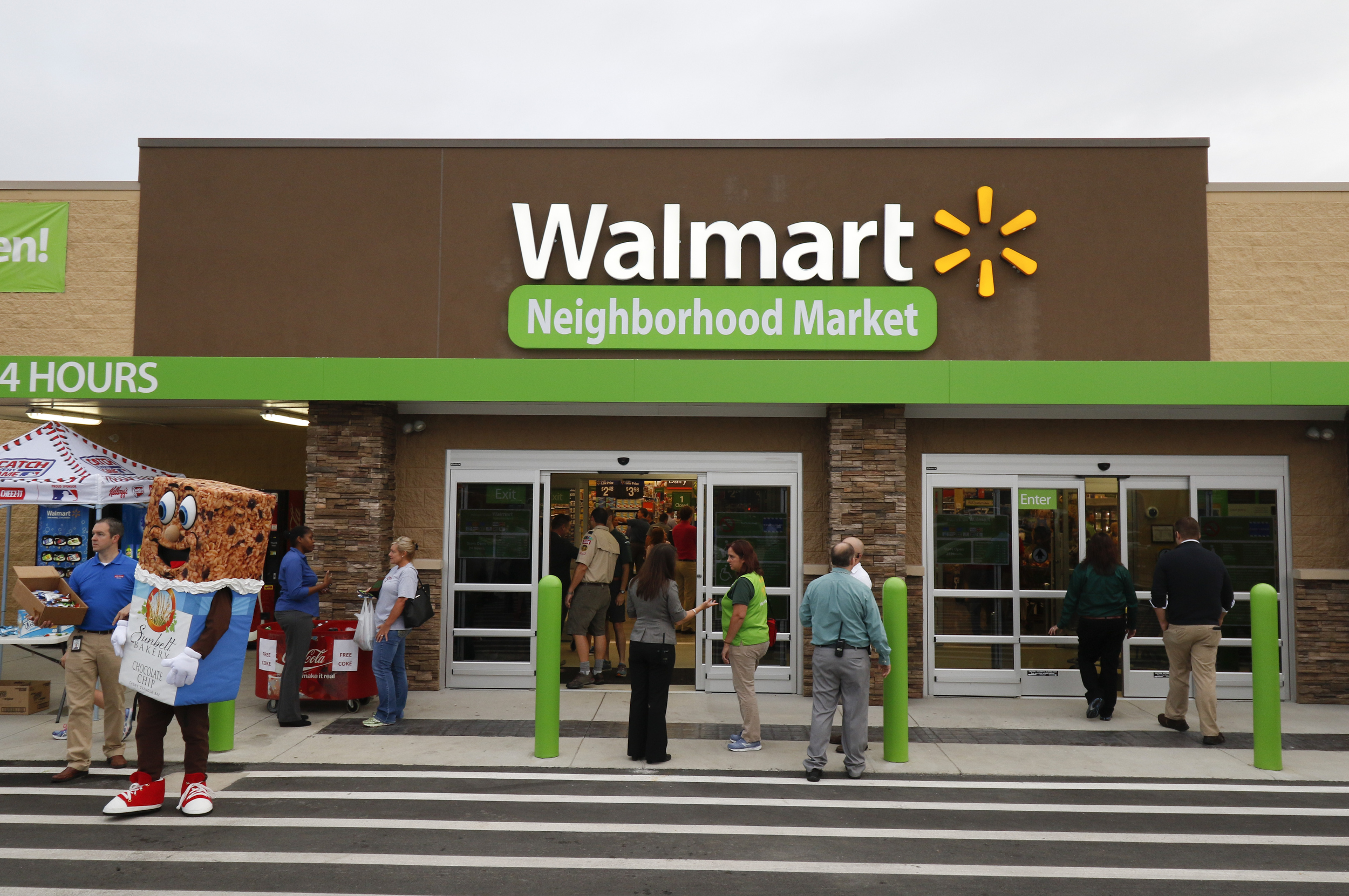 Patrons enter the new building during the grand opening of the Walmart Neighborhood Market off of East Brainerd Road in Chattanooga, Tenn., on September 9, 2015.