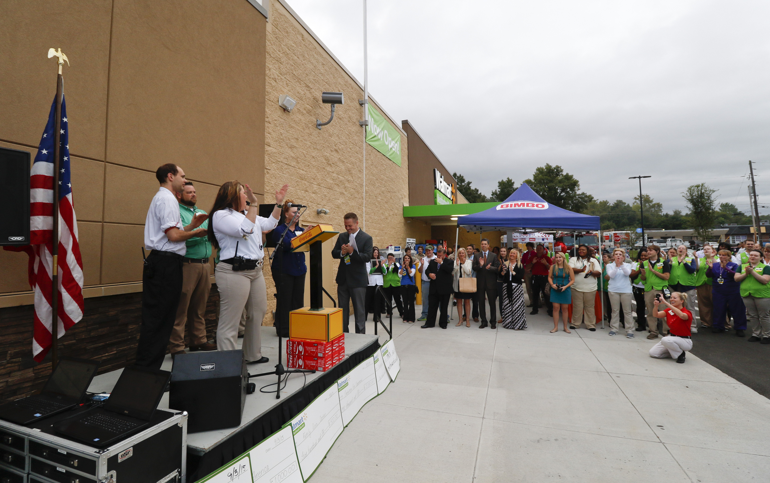 Management lead employees in the "Walmart Cheer" during the grand opening of the Walmart Neighborhood Market off of East Brainerd Road in Chattanooga, Tenn., on September 9, 2015.