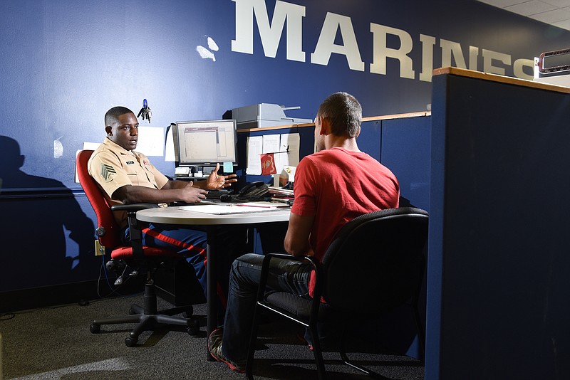 Marine Sgt. DeMonte Cheeley, left, interviews Andrew Soucie, a prospective recruit, inside the offices on Lee Highway.