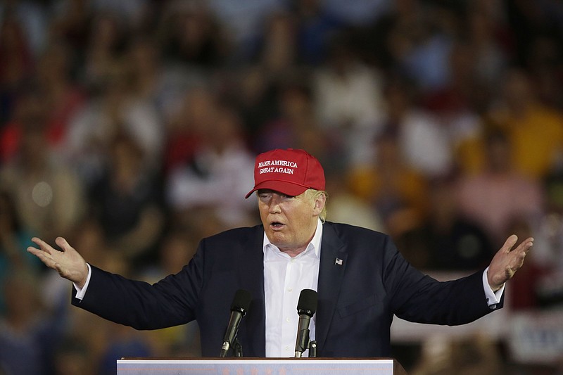 Republican presidential candidate businessman Donald Trump, wearing his signature ball cap with campaign slogan "Making America Great Again," speaks during a campaign pep rally in Mobile, Ala., in August.