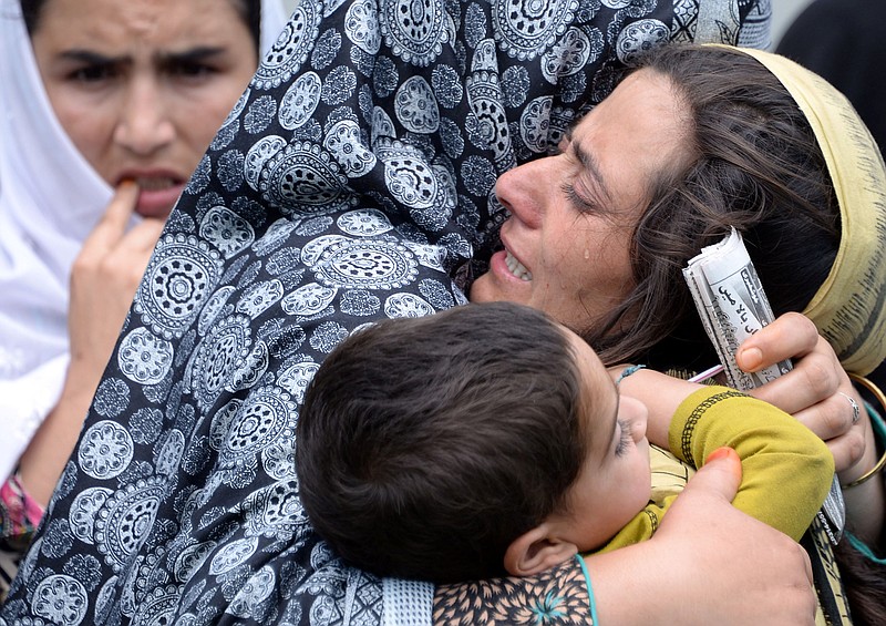 
              In this Wednesday, Aug. 5, 2015 photo, family members of Shafqat Hussain, who was convicted and hanged for killing a boy, mourn his death in Muzaffarabad, Pakistani Kashmir. Pakistan quickly has become one of the world’s top executioners following a Taliban attack on a military school after years of not carrying out a death sentence, but instead of killing militants, it routinely executes common criminals, The Associated Press has found. (AP Photo/M.D. Mughal)
            