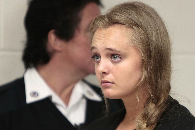 
              FILE - In this Aug. 24, 2015 file photo, Michelle Carter listens to defense attorney Joseph P. Cataldo argue for an involuntary manslaughter charge against her to be dismissed at Juvenile Court in New Bedford, Mass. Carter, 18, of Plainville, Mass., is charged with involuntary manslaughter for allegedly pressuring Conrad Roy III, 18, of Fairhaven, Mass., to commit suicide on July 13, 2014. (Peter Pereira/The New Bedford Standard Times via AP, Pool, File)
            