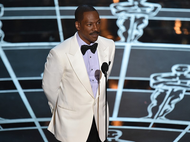 
              FILE - In this Feb. 22, 2015 file photo, Eddie Murphy presents the award for best original screenplay at the Oscars on Sunday, Feb. 22, 2015, at the Dolby Theatre in Los Angeles.  Chris Rock, Kathy Griffin, Arsenio Hall and other leading comedians will perform next month in honor of Eddie Murphy as he receives the nation’s top prize for humor at the Kennedy Center in Washington. The Kennedy Center announced a lineup of stars Wednesday, Sept. 9, 2015,  who will salute Murphy on Oct. 18 with the Mark Twain Prize for American Humor. (Photo by John Shearer/Invision/AP)
            