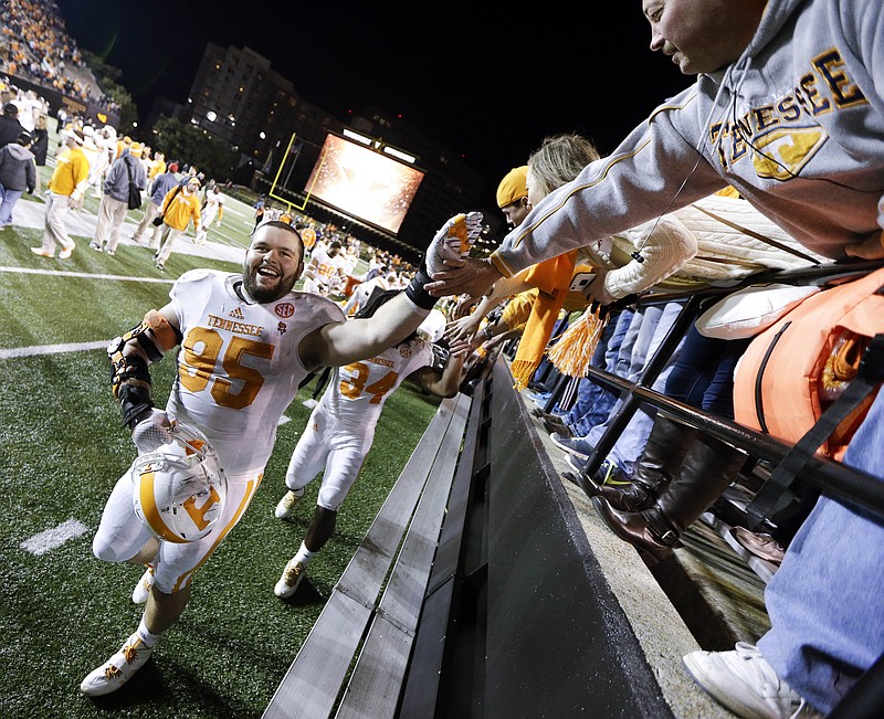 Tennessee defensive lineman Danny O'Brien (95) celebrates with fans as he leaves the field following a 24-17 win over Vanderbilt in an NCAA college football game Saturday, Nov. 29, 2014, in Nashville, Tenn. (AP Photo/Mark Humphrey)