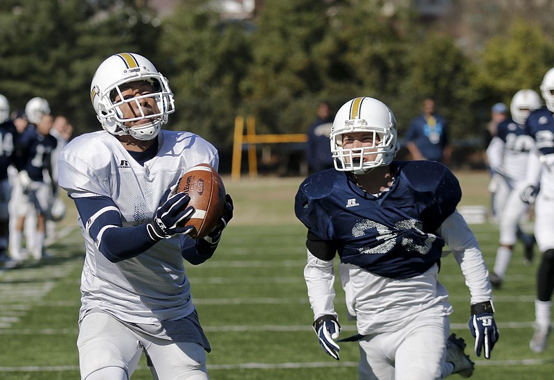 UTC wide receiver C.J. Board, left, catches a pass ahead of defensive back Ryan Bossung during the Mocs' first spring football scrimmage Saturday, March 28, 2015, at Scrappy Moore Field in Chattanooga, Tenn.