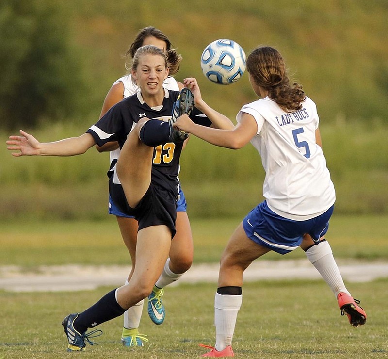 Chattanooga Christian School's Leah Hoffman, left, clears the ball from Boyd-Buchanan's Emily Hauke during a match at Boyd-Buchanan High School last month. CCS is the first TSSAA school to elect to move from Division I to II since new rules were passed regarding private schools in the organization.
