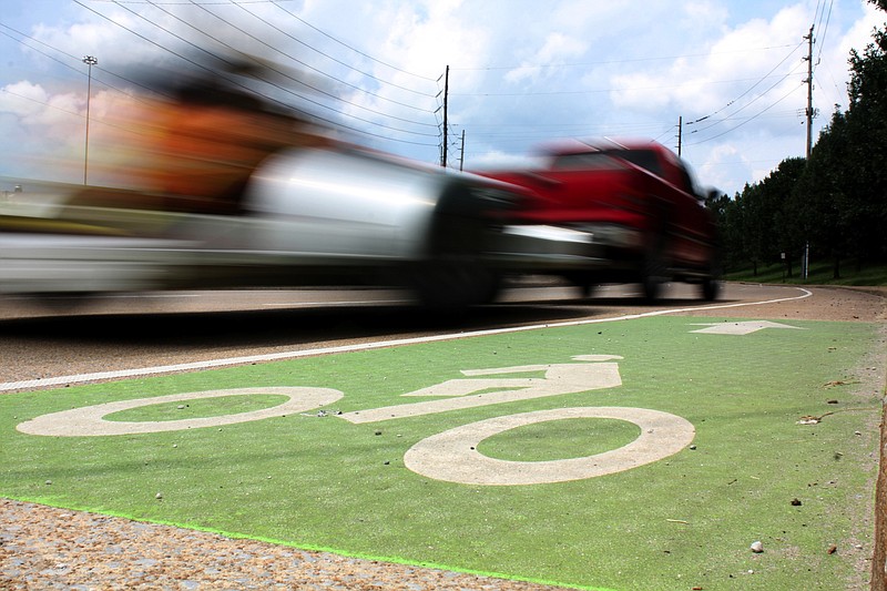 A truck drives on West 22nd Street next to a bike lane. Bike lanes, as well as lower downtown speed limits, are part of Mayor Andy Berke's safer streets plan.