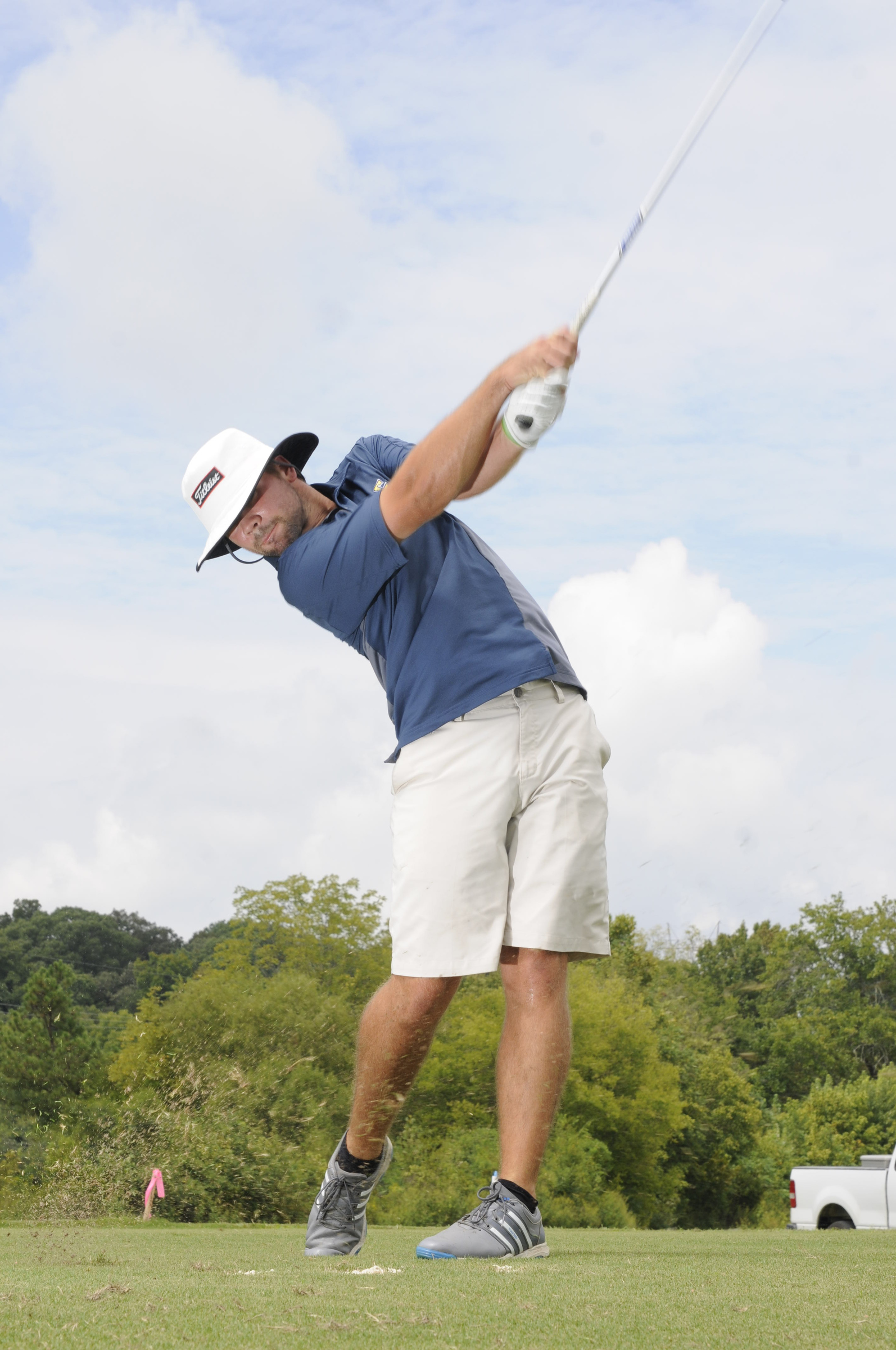 Brooks Thomas hits short iron shots Wednesday during practice at the UTC Golf center on Hickory Valley Road.