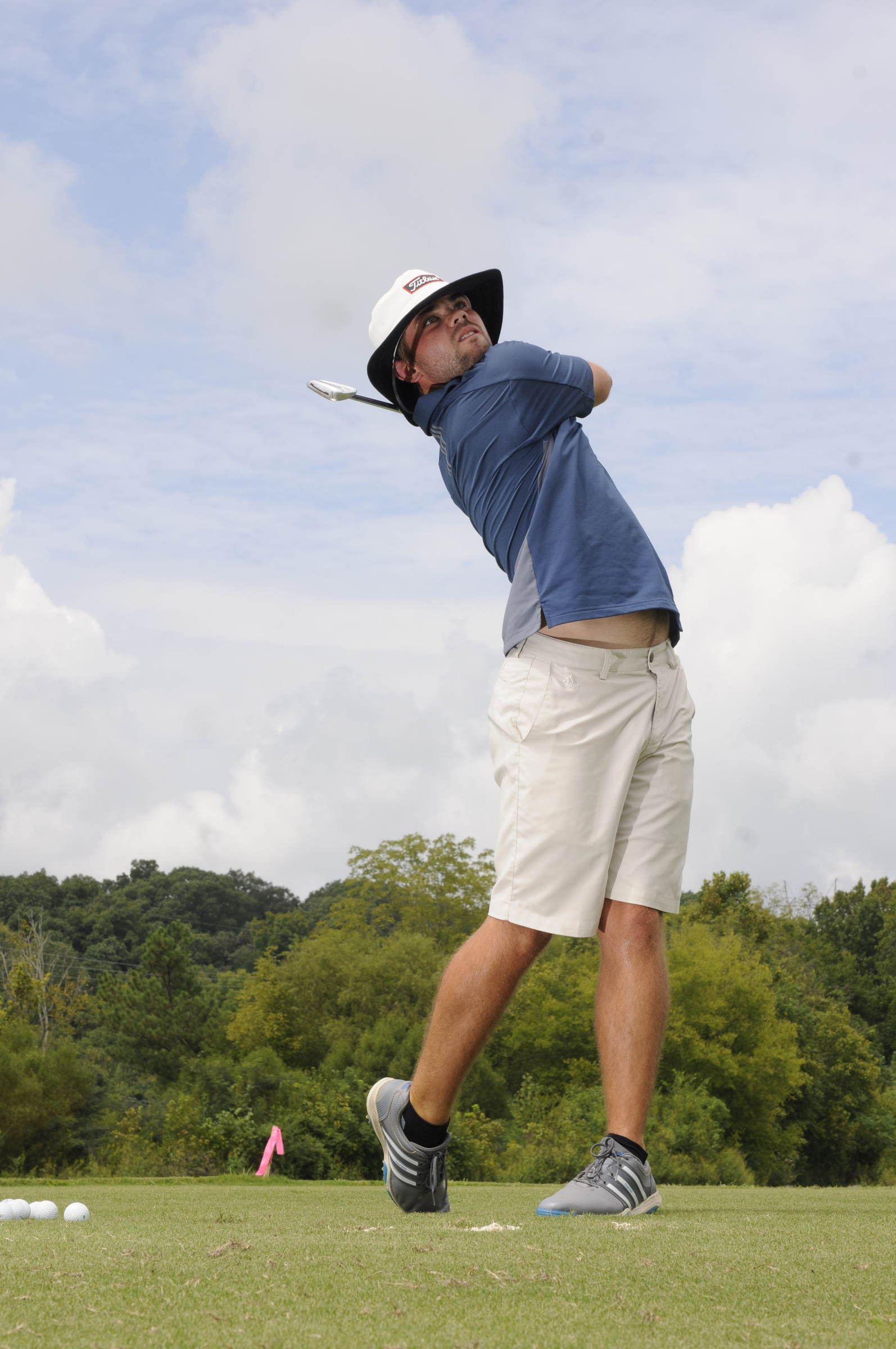 Brooks Thomas hits short iron shots Wednesday during practice at the UTC Golf center on Hickory Valley Road.