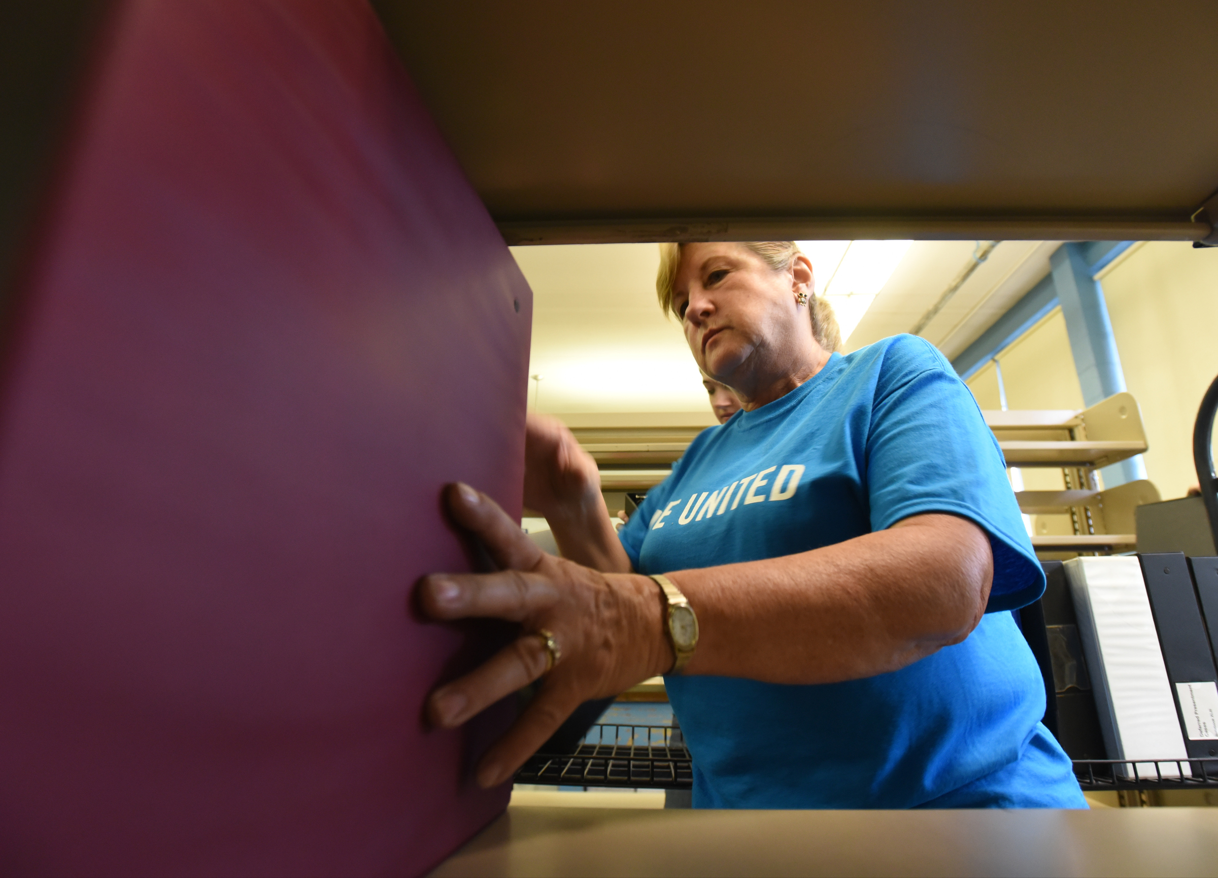 Elder's Ace Hardware employee Mavis Knowles shelves binders during the United Way day of caring Thursday, September 10, 2015, at the Teacher Supply Depot on Roanoke Avenue.