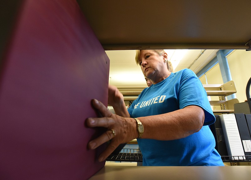 Elder's Ace Hardware employee Mavis Knowles shelves binders during the United Way day of caring Thursday, September 10, 2015, at the Teacher Supply Depot on Roanoke Avenue.
