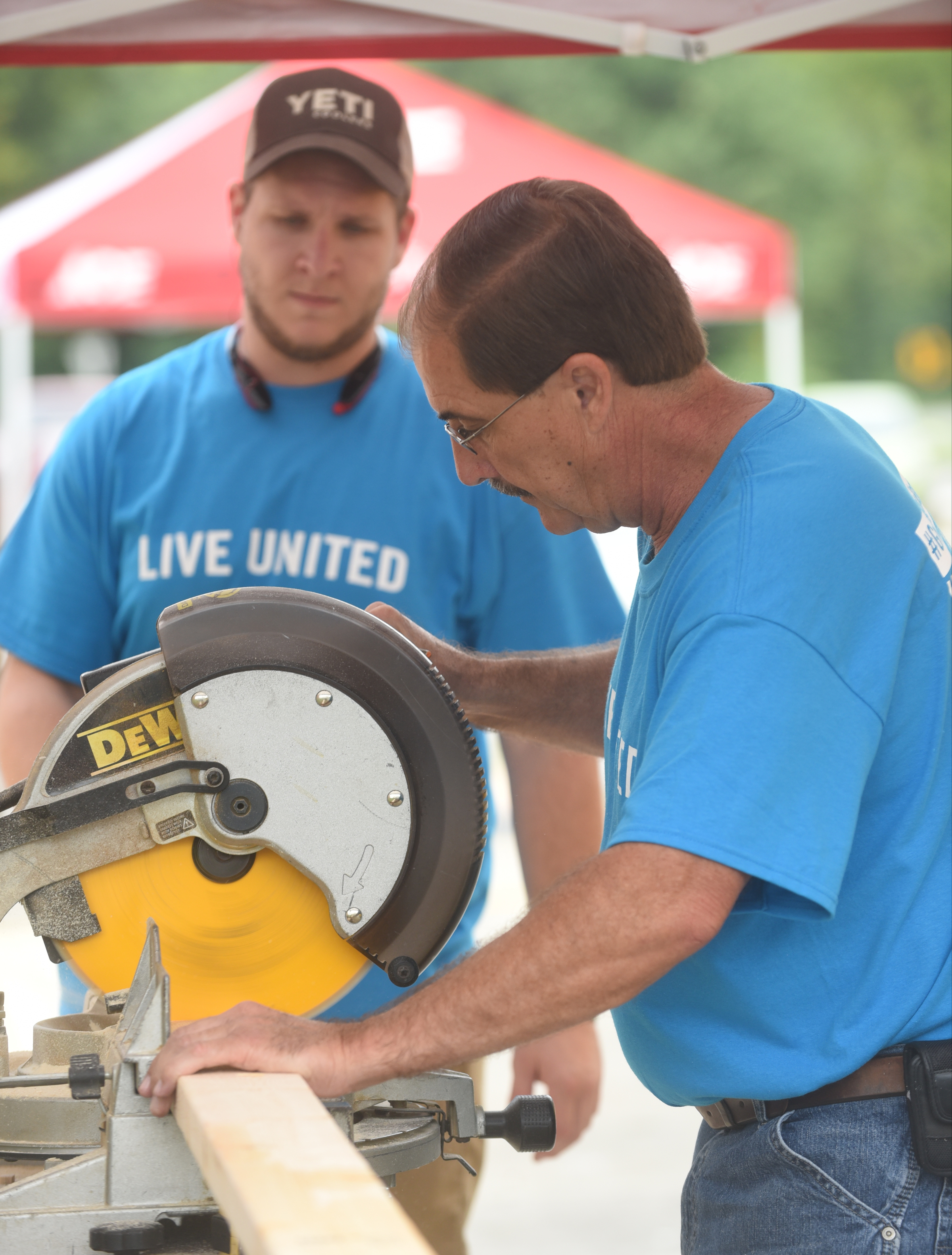 Elder's Ace Hardware employees Tim Dennison, right, and Matt Gardenhire work during the United Way day of caring Thursday, September 10, 2015, at the Teacher Supply Depot on Roanoke Avenue.