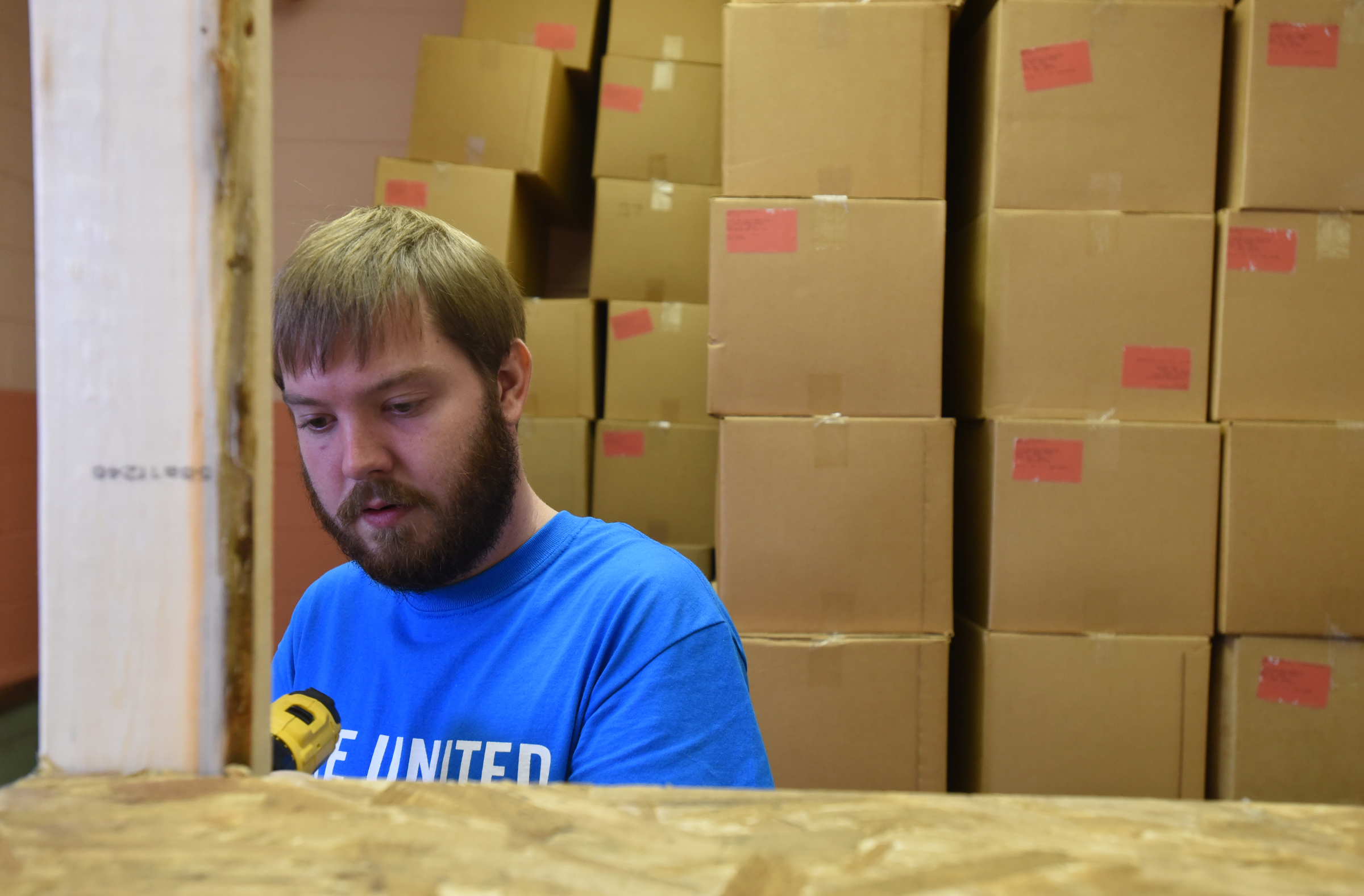 Elder's Ace Hardware employee Cody McIntire builds shelves during the United Way day of caring Thursday, September 10, 2015, at the Teacher Supply Depot on Roanoke Avenue.