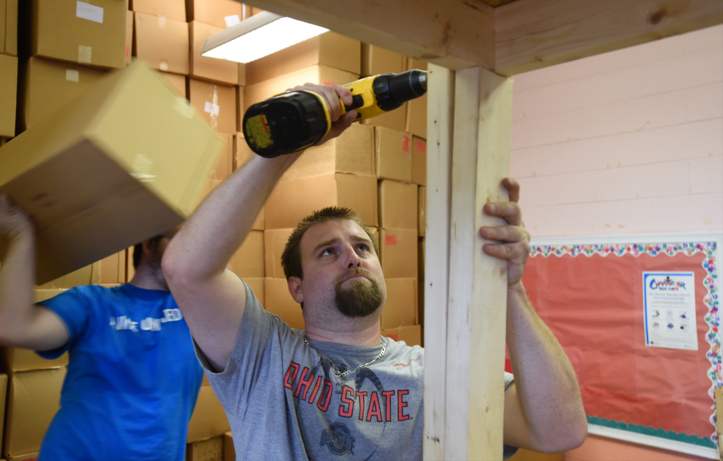Elder's Ace Hardware employee Matt Huebner builds shelves during the United Way day of caring Thursday, September 10, 2015, at the Teacher Supply Depot on Roanoke Avenue.