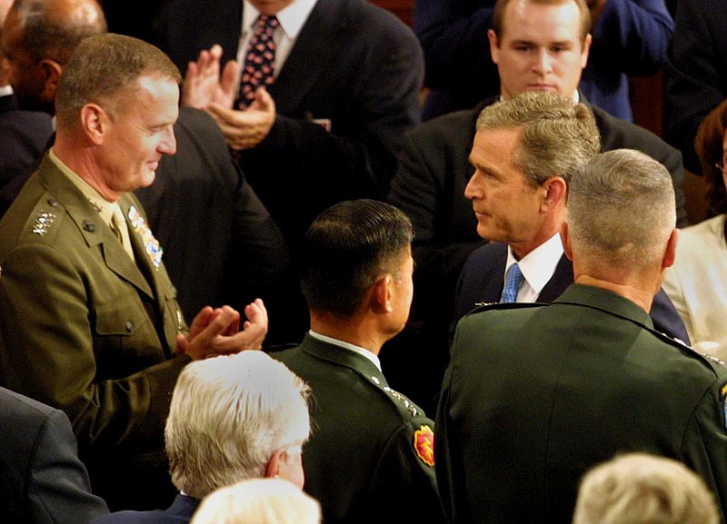 President George Bush greets members of the Joint Chiefs of Staff as he was set to address a joint session of Congress on Sept. 20, 2001. Bush sought to prepare the nation for war, vowing in the speech to "direct every resource at our command" to avenge the worst terrorist attacks against the United States in its history.