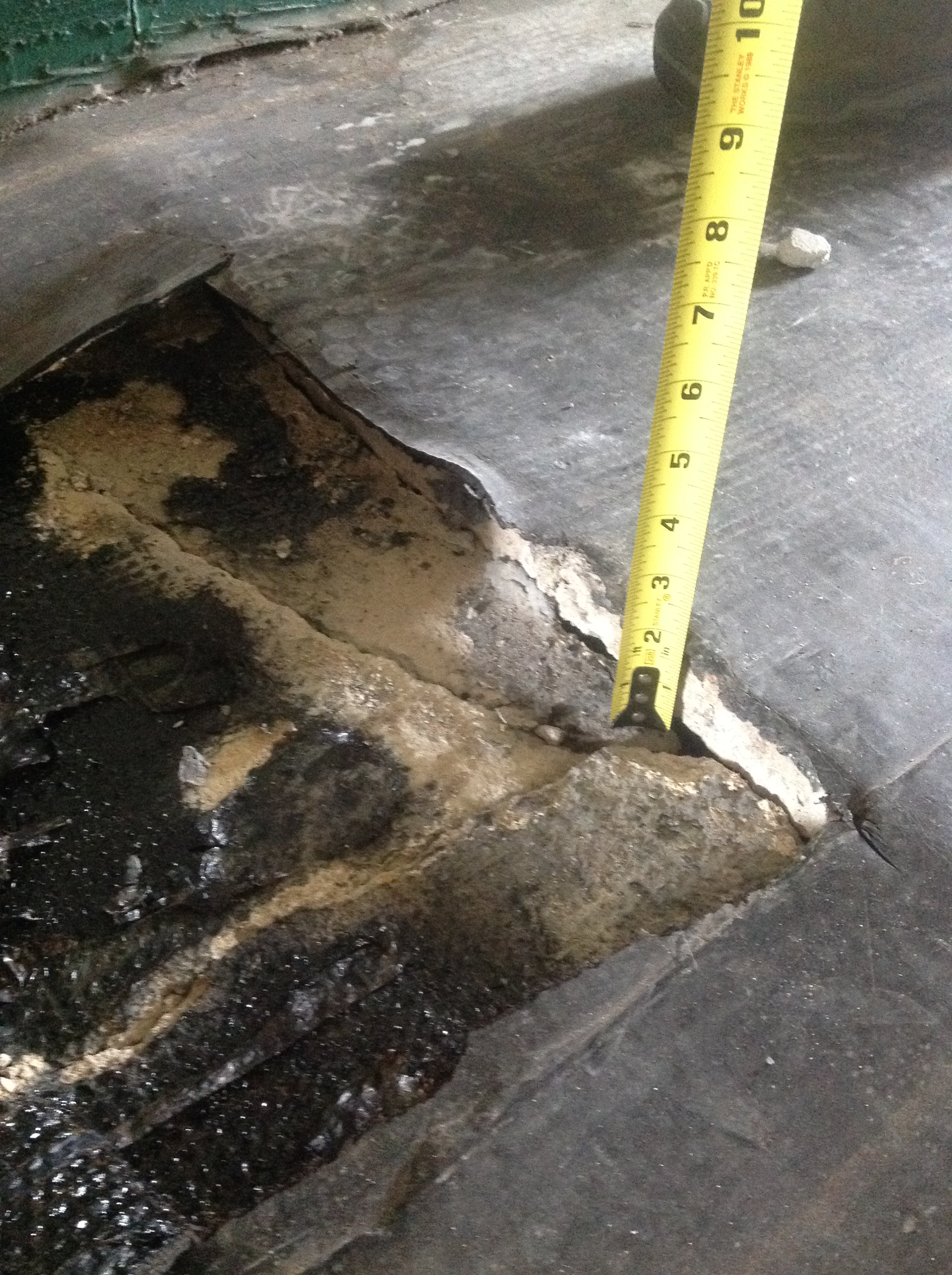 City officials measure a hole at Superior Creek Lodge.