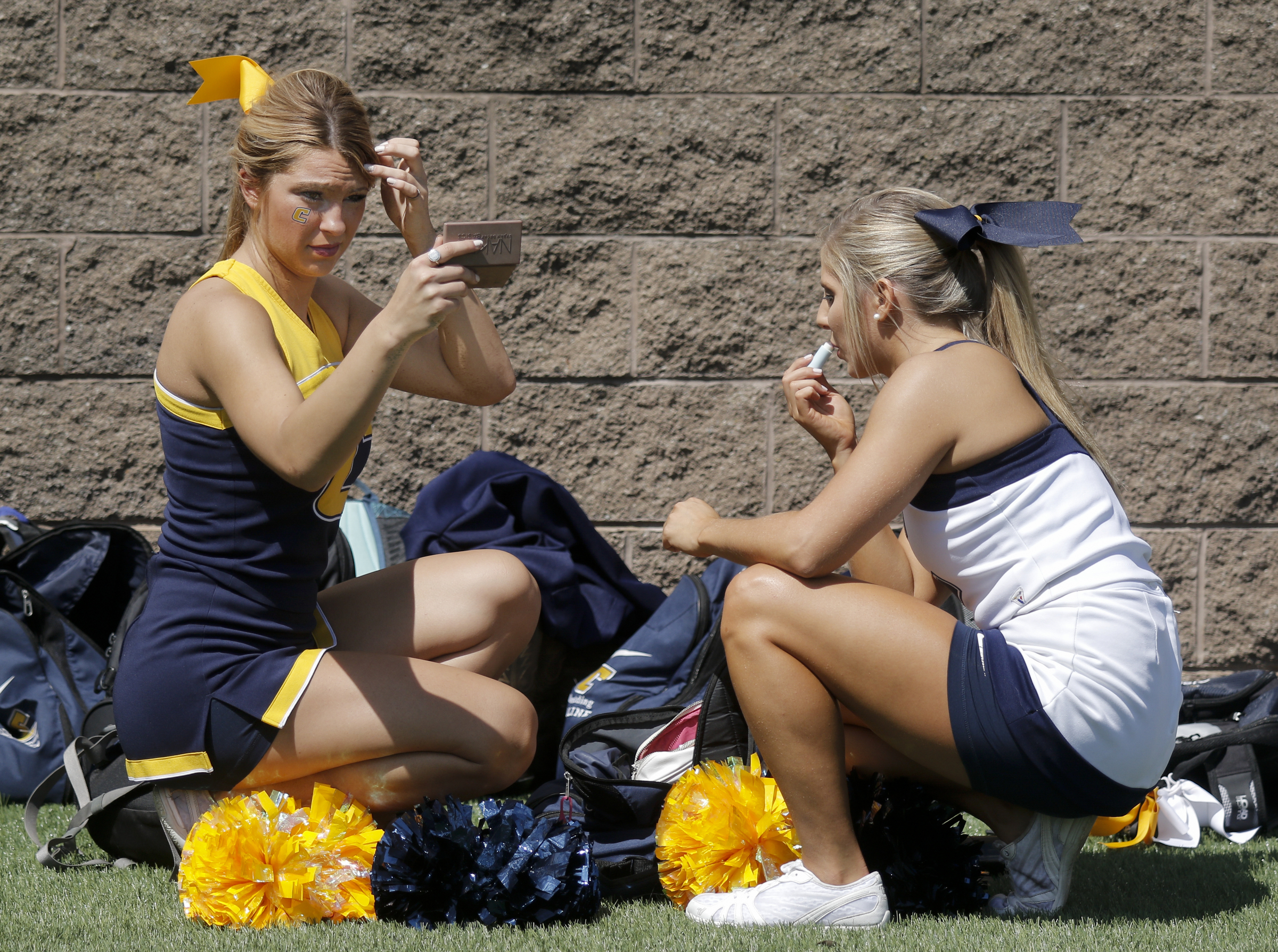 UTC cheerleaders Chelsea Newsom, left, and Taylor Woods put finishing touches on their hair and makeup before the Mocs' football game against the Mars Hill Lions at Finley Stadium on Saturday, Sept. 12, 2015, in Chattanooga, Tenn. UTC won 44-34.