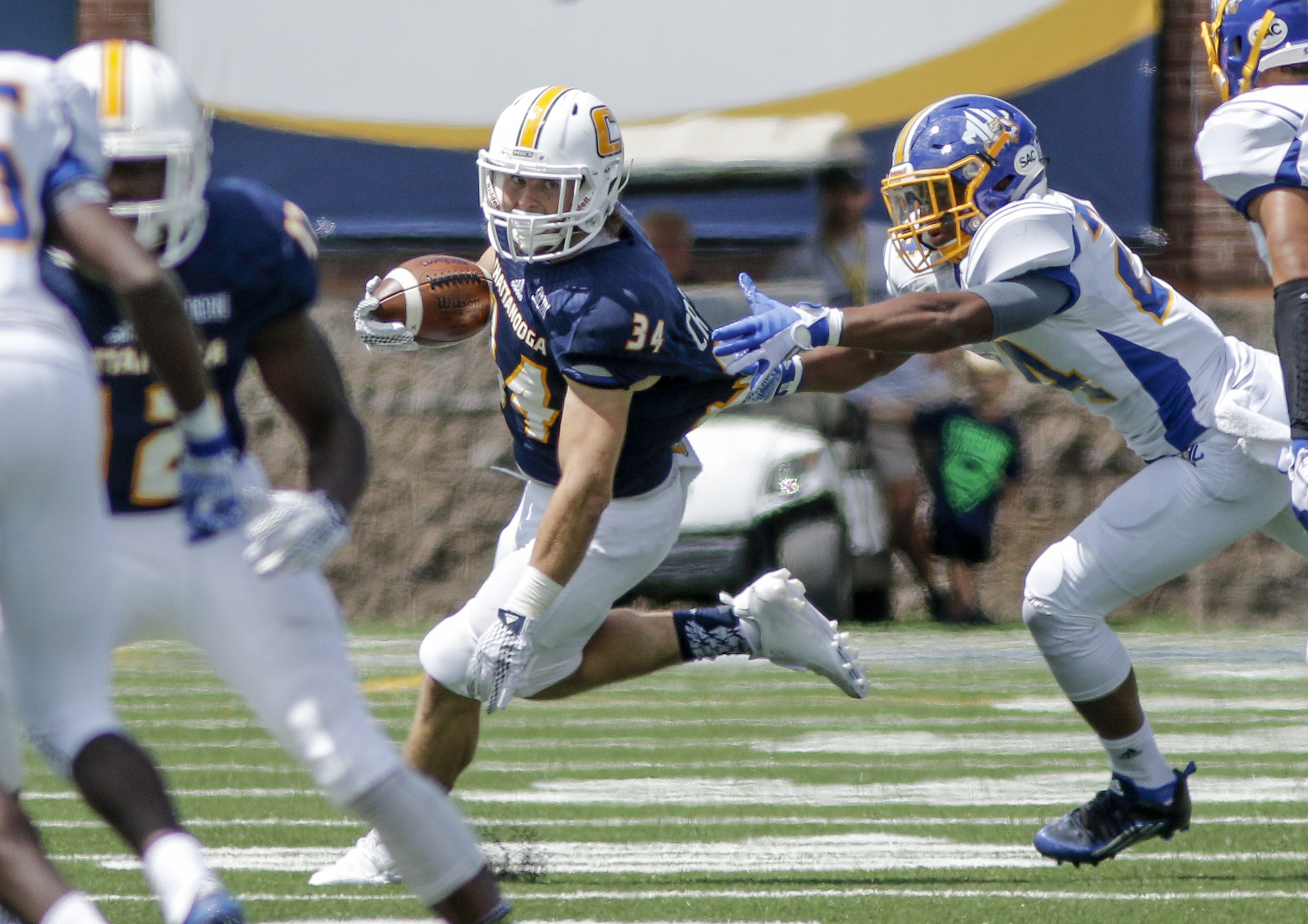 UTC running back Derrick Craine slips a tackle by Mars Hill defensive back Carl Mattox during the Mocs' football game against the Lions at Finley Stadium on Saturday, Sept. 12, 2015, in Chattanooga, Tenn. UTC won 44-34.