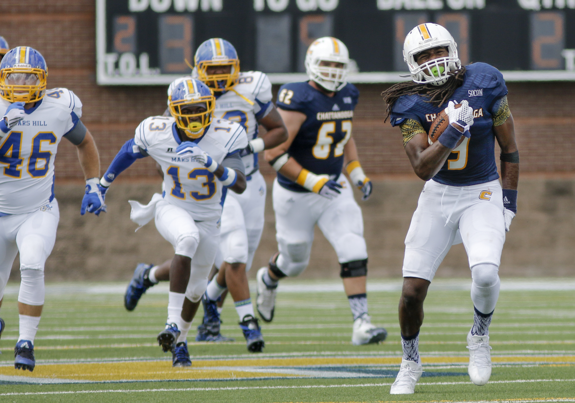 UTC wide receiver Alphonso Stewart grabs his leg as an aggravated muscle slows him down after a long run during the Mocs' football game against the Mars Hill Lions at Finley Stadium on Saturday, Sept. 12, 2015, in Chattanooga, Tenn. UTC won 44-34.