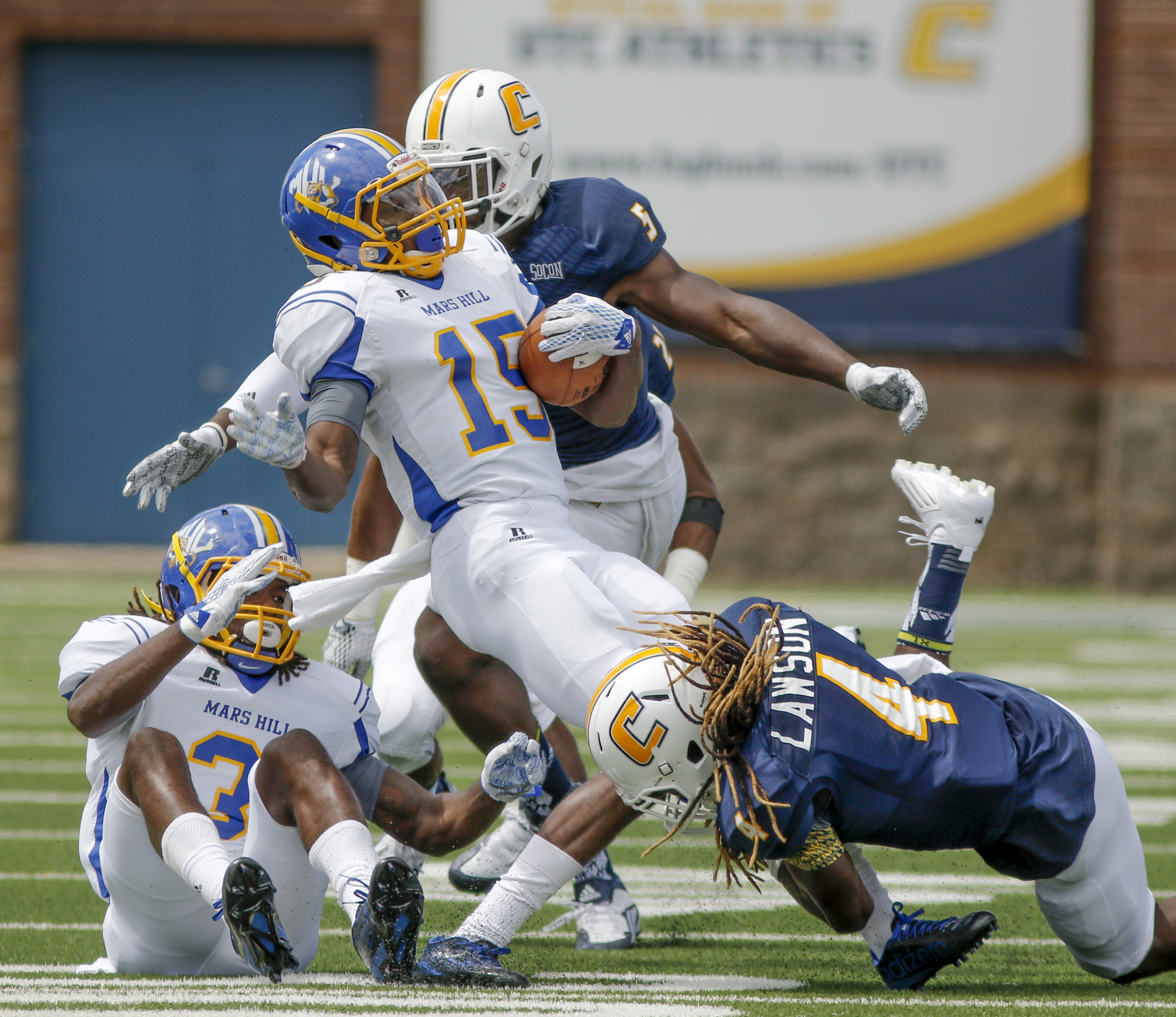 UTC defensive back Tavon Lawson, right, and linebacker Nakevian Leslie tackle Mars Hill wide receiver Keshaun Taylor during the Mocs' football game against the Lions at Finley Stadium on Saturday, Sept. 12, 2015, in Chattanooga, Tenn. UTC won 44-34.