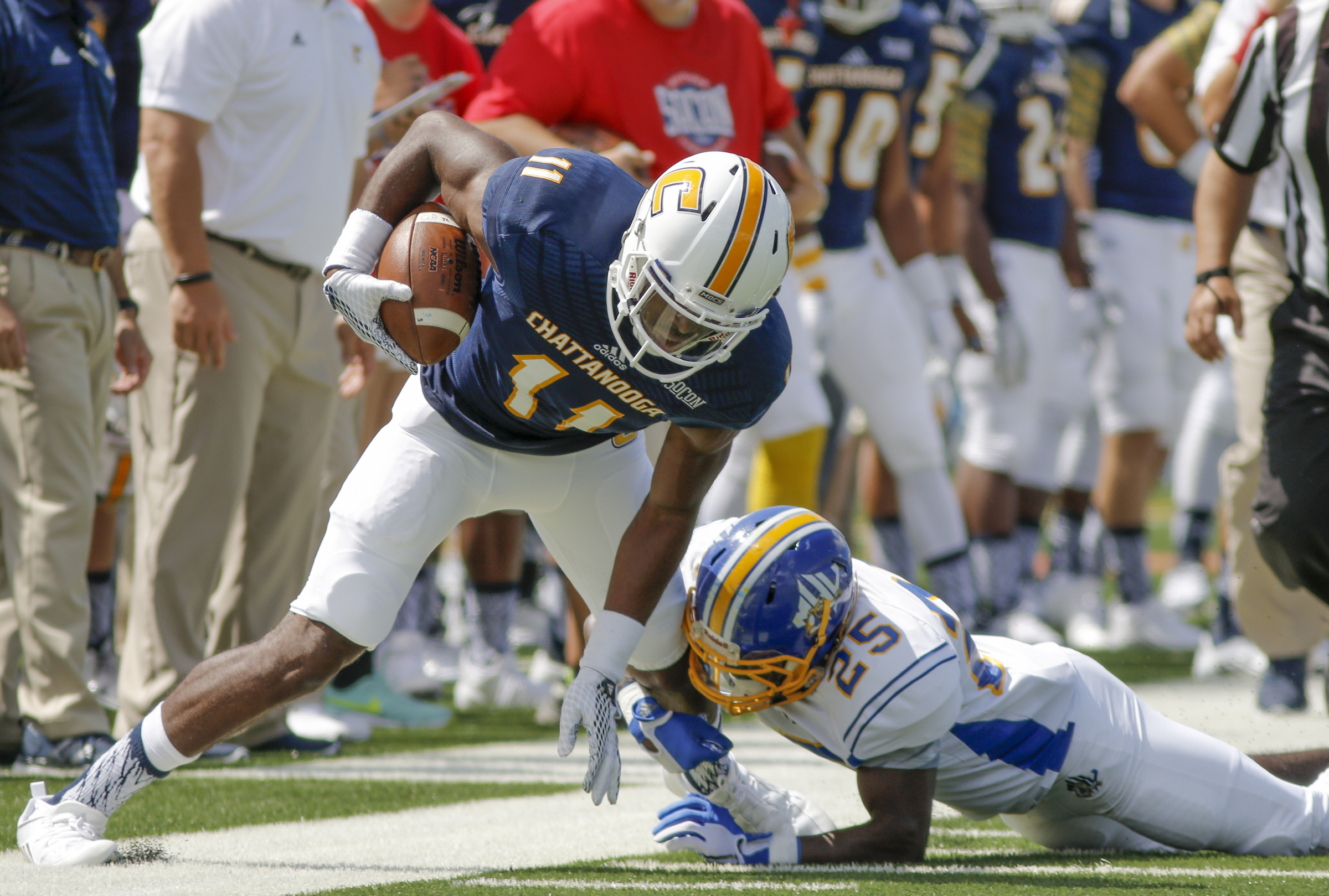 UTC wide receiver Wil Young is forced out of bounds by Mars Hill defensive back Robert Morgan, Jr., during the Mocs' football game against the Lions at Finley Stadium on Saturday, Sept. 12, 2015, in Chattanooga, Tenn. UTC won 44-34.