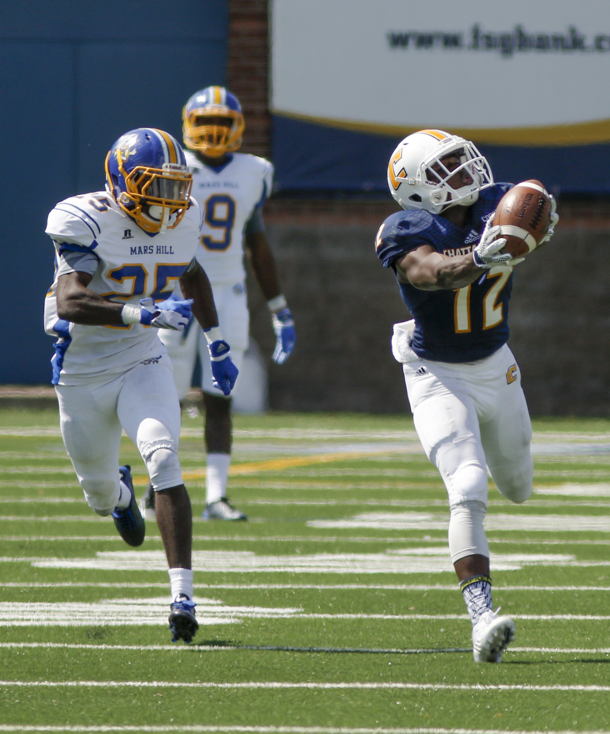 UTC wide receiver Xavier Borishade, right, catches a deep pass ahead of Mars Hill defensive back Robert Morgan, Jr., during the Mocs' football game against the Lions at Finley Stadium on Saturday, Sept. 12, 2015, in Chattanooga, Tenn. UTC won 44-34.