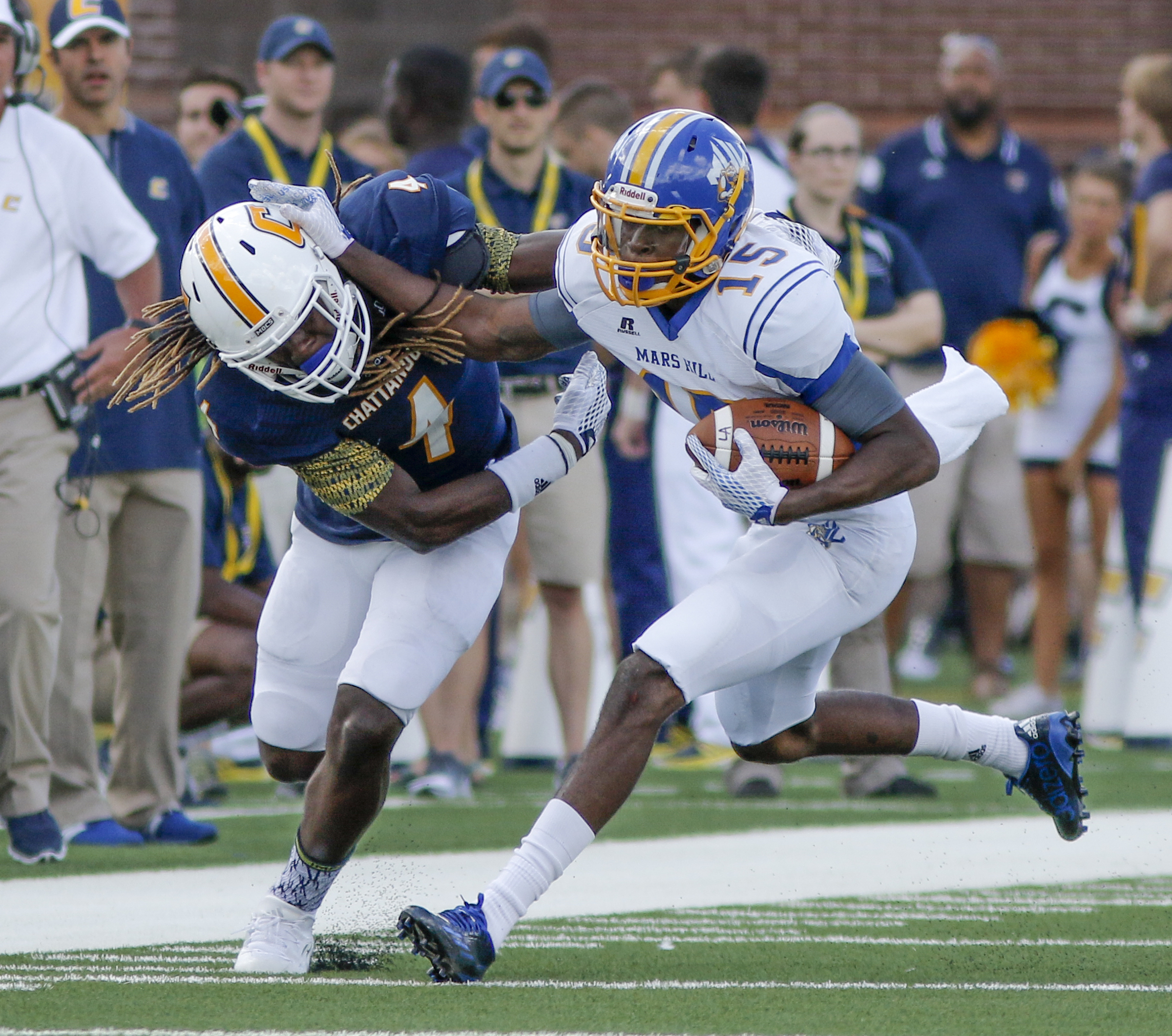 UTC defensive back Tavon Lawson, left, tackles Mars Hill wide receiver Keshaun Taylor during the Mocs' football game against the Lions at Finley Stadium on Saturday, Sept. 12, 2015, in Chattanooga, Tenn. UTC won 44-34.