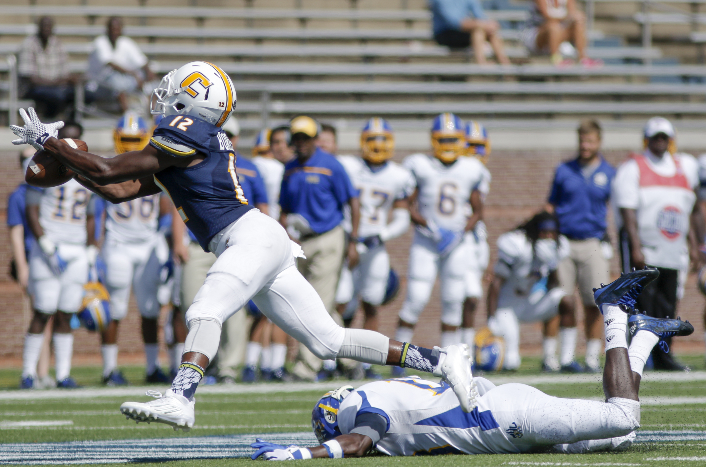 A pass slips through the hands of UTC wide receiver Xavier Borishade as Mars Hill defensive back Nicolas Sanders falls to the ground during the Mocs' football game against the Lions at Finley Stadium on Saturday, Sept. 12, 2015, in Chattanooga, Tenn. UTC won 44-34.