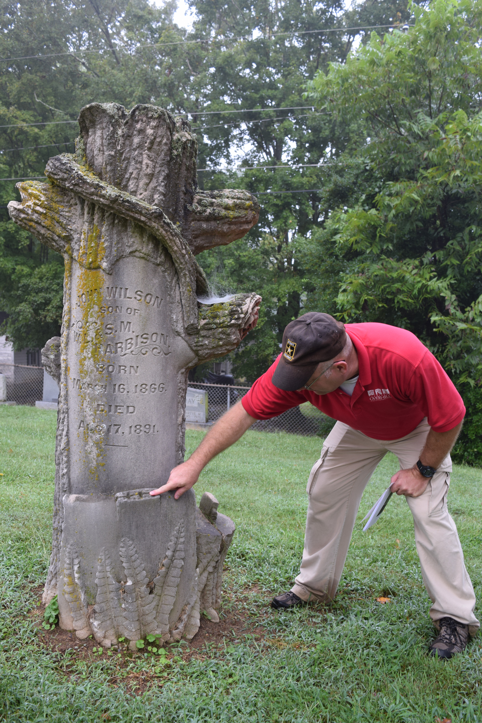 Tennessee Overhill Heritage Association executive director Gerald Hodge looks closely at the detailing on a Woodmen of the World marker at Cedar Grove Cemetery in Athens, Tenn. The association is conducting a study of odd and unusual graves in McMinn, Monroe and Polk counties.
