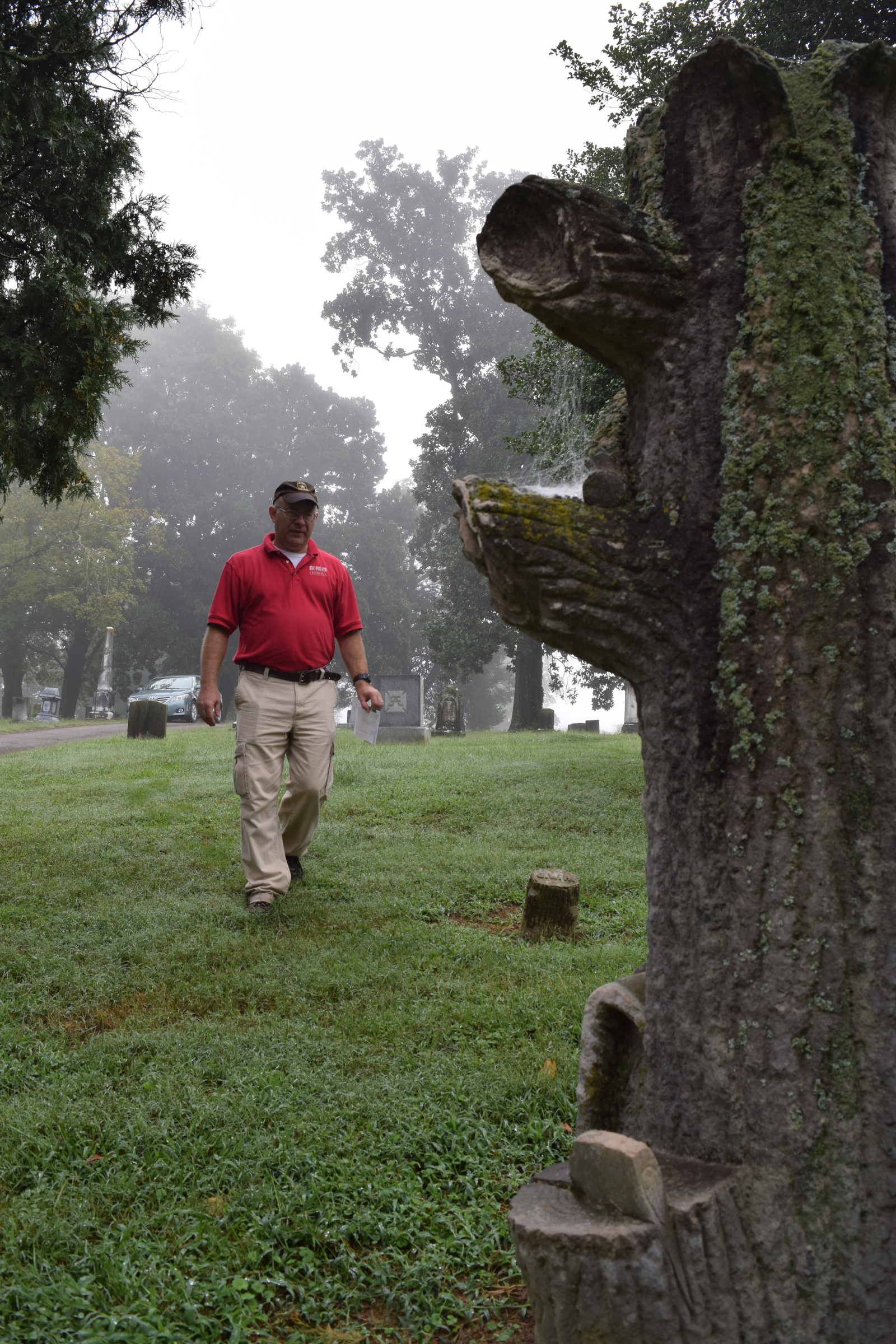 Tennessee Overhill Heritage Association executive director Gerald Hodge looks closely at the detailing on a Woodmen of the World marker at Cedar Grove Cemetery in Athens, Tenn. The association is conducting a study of odd and unusual graves in McMinn, Monroe and Polk counties.