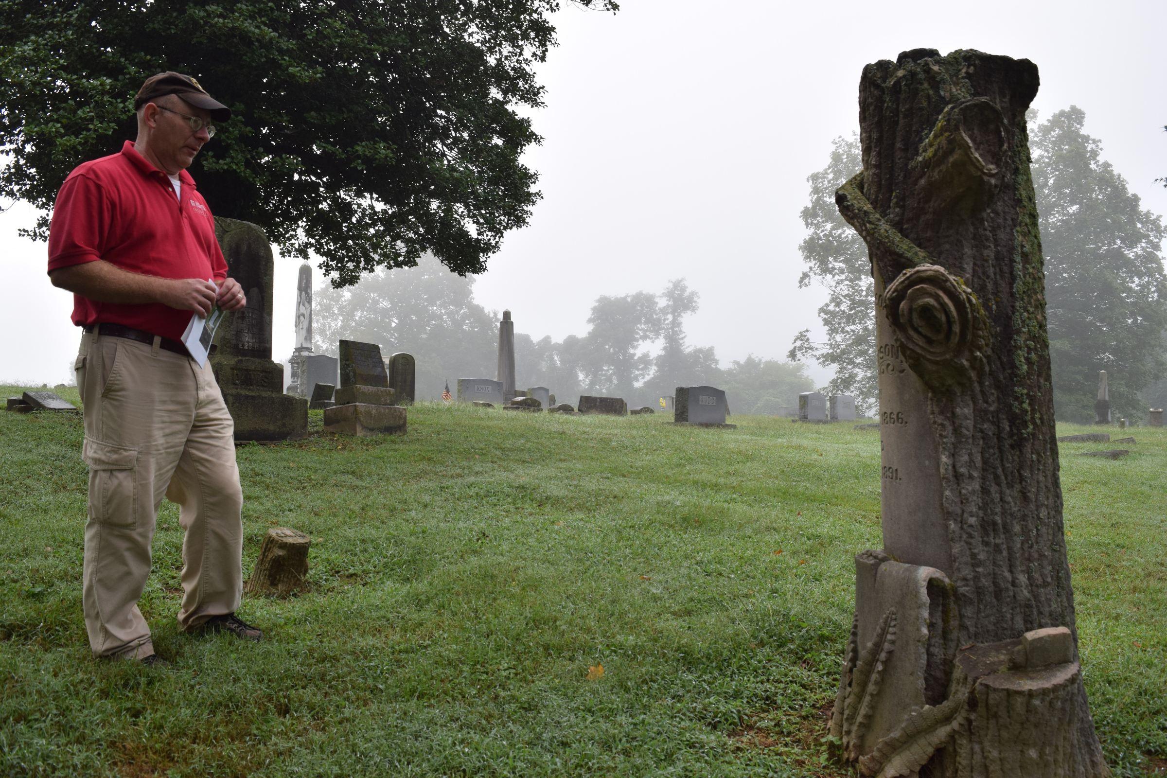Tennessee Overhill Heritage Association executive director Gerald Hodge looks closely at the detailing on a Woodmen of the World marker at Cedar Grove Cemetery in Athens, Tenn. The association is conducting a study of odd and unusual graves in McMinn, Monroe and Polk counties.