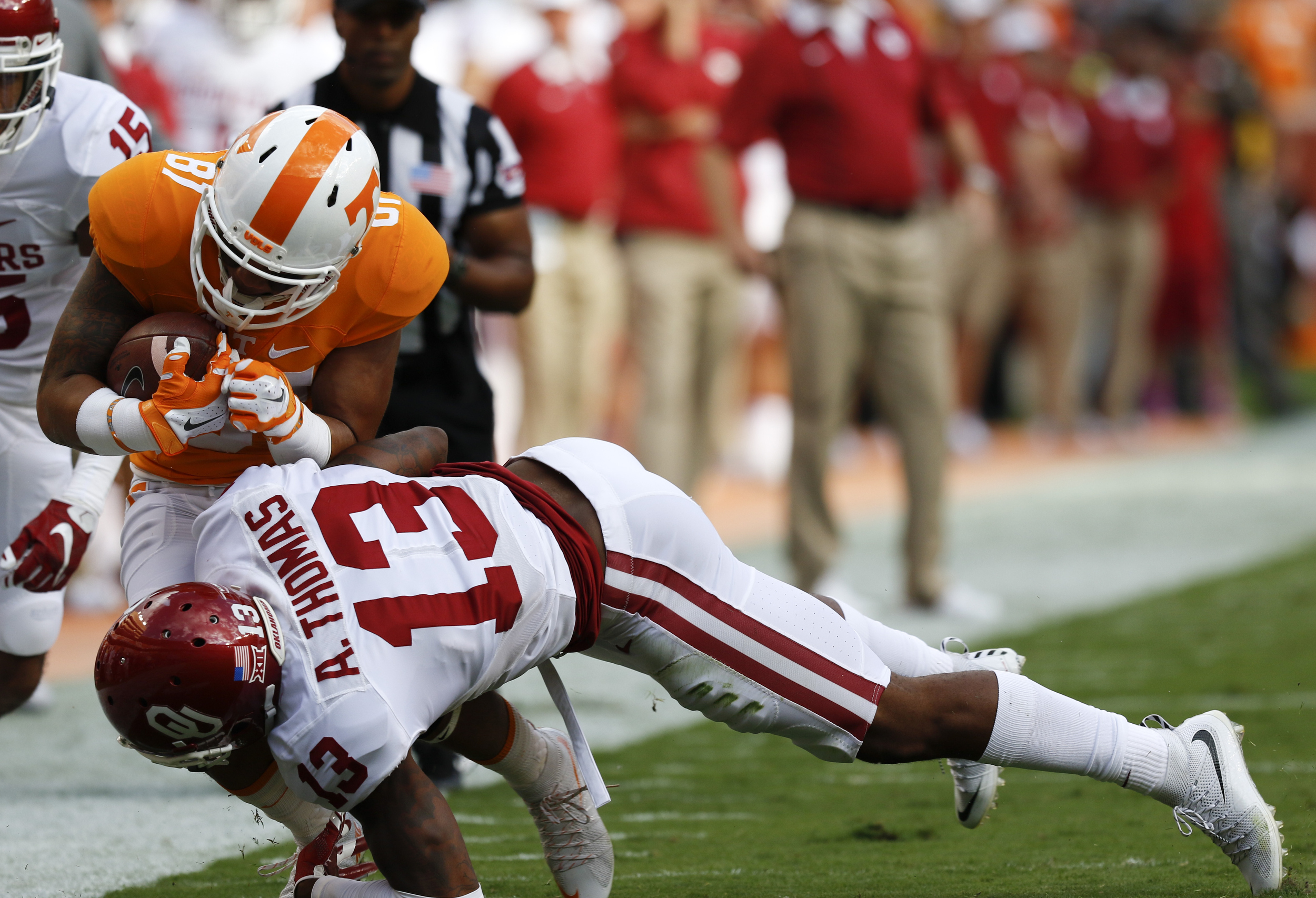 UT's Johnathon Johnson (81) is knocked out of bounds by Oklahoma's Ahmad Thomas (13) during the first half of play Saturday. The Volunteers played the Sooner's at home on September 12, 2015 at Neyland Stadium in Knoxville, Tennessee.