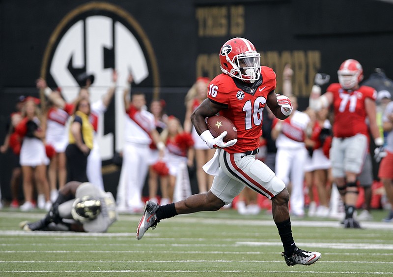 Georgia's Isaiah McKenzie (16) returns a punt 77 yards for a touchdown against Vanderbilt in the first half of an NCAA college football game Saturday, Sept. 12, 2015, in Nashville.