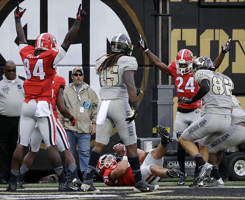 Georgia's Leonard Floyd (84) and Dominick Sanders (24) celebrate after linebacker Jake Ganus (51) intercepted a pass in the end zone against Vanderbilt in the second half of an NCAA college football game Saturday, Sept. 12, 2015, in Nashville. Georgia won 31-14.