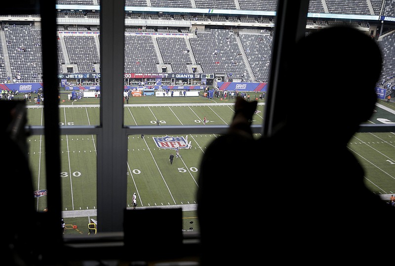 
              In this photo taken Aug. 29, 2015, Jim Gossett points out something on the field before a pre-season football game between the New York Giants and New York Jets at Met Life Stadium in East Rutherford, N.J. For the first time, the NFL is giving spotters in the press box the power to call a medical timeout. Previously, only coaches or referees could stop the clock. (AP Photo/Seth Wenig)
            
