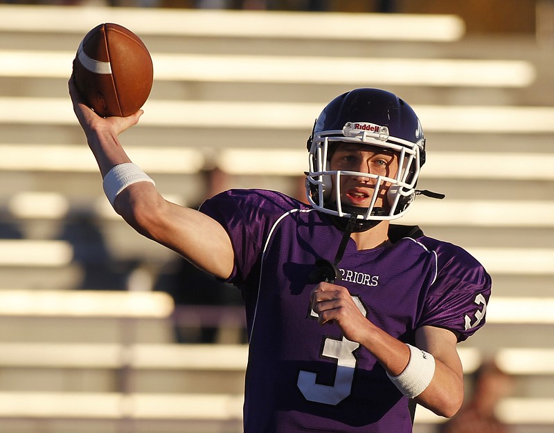 Marion County quarterback Logan Walters warms up before their  game on Nov. 1, 2013, at Marion County High School in Jasper, Tenn.